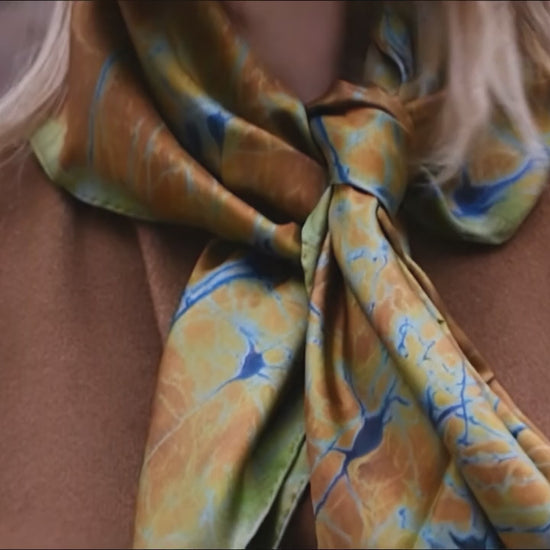 Woman wearing the Neurona silk scarf