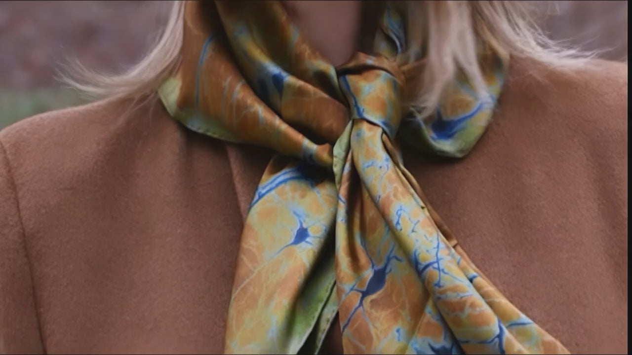 Woman wearing the Neurona silk scarf