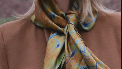 Woman wearing the Neurona silk scarf